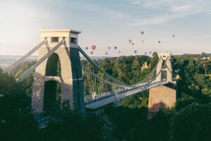A magnificent suspension bridge with elegant arches and towers, stretching across a picturesque gorge.